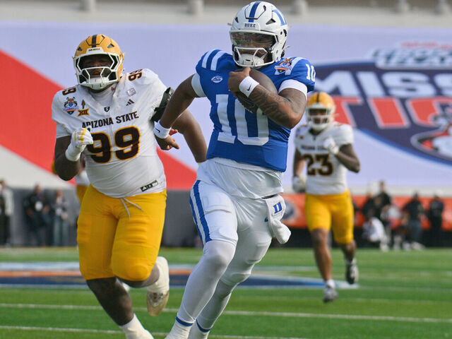 EL PASO, TEXAS - DECEMBER 31: Quarterback Darian Mensah #10 of the Duke Blue Devils scrambles for yardage against defensive lineman C.J. Fite #99 of the Arizona State Sun Devils during the second half of the Tony The Tiger Sun Bowl game at Sun Bowl Stadium on December 31, 2025 in El Paso, Texas. The Blue Devils defeated the Sun Devils 42-39.