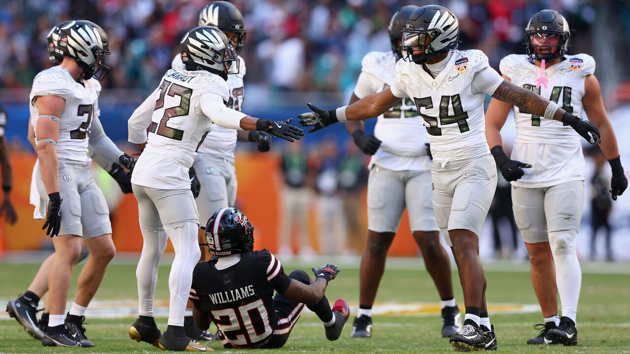 MIAMI GARDENS, FLORIDA - JANUARY 01: Jadon Canady #22 and Jerry Mixon #54 of the Oregon Ducks celebrate after a play against the Texas Tech Red Raiders in the third quarter during the 2025 College Football Playoff Quarterfinal at the Capital One Orange Bowl at Hard Rock Stadium on January 01, 2026 in Miami Gardens, Florida.