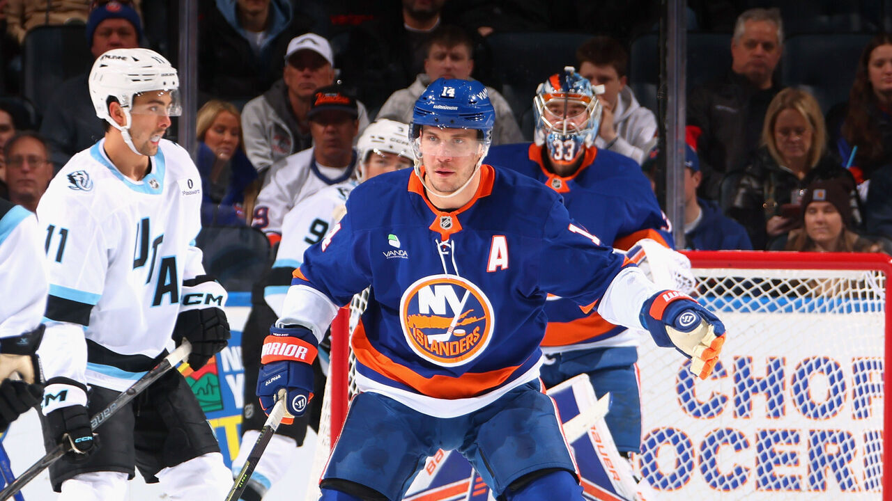 ELMONT, NEW YORK - JANUARY 01: Bo Horvat #14 of the New York Islanders defends against the Utah Mammoth during the second period at UBS Arena on January 01, 2026 in Elmont, New York.