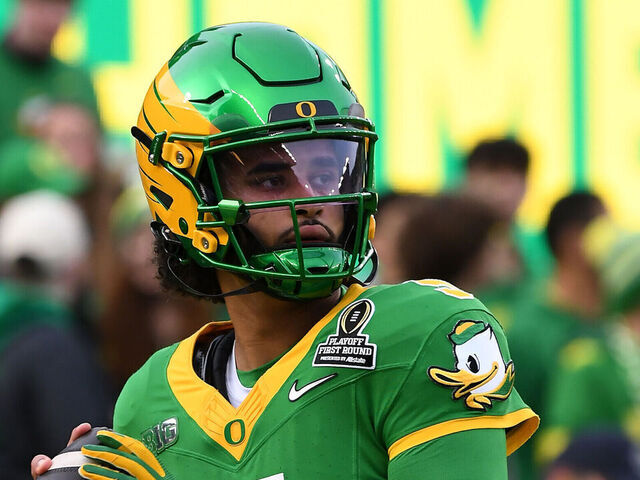 EUGENE, OR - DECEMBER 20: Oregon Ducks quarterback Dante Moore (5) warms up before the College Football Playoff first round game between the Oregon Ducks and James Madison Dukes on December 20, 2025 at Autzen Stadium in Eugene, Oregon.