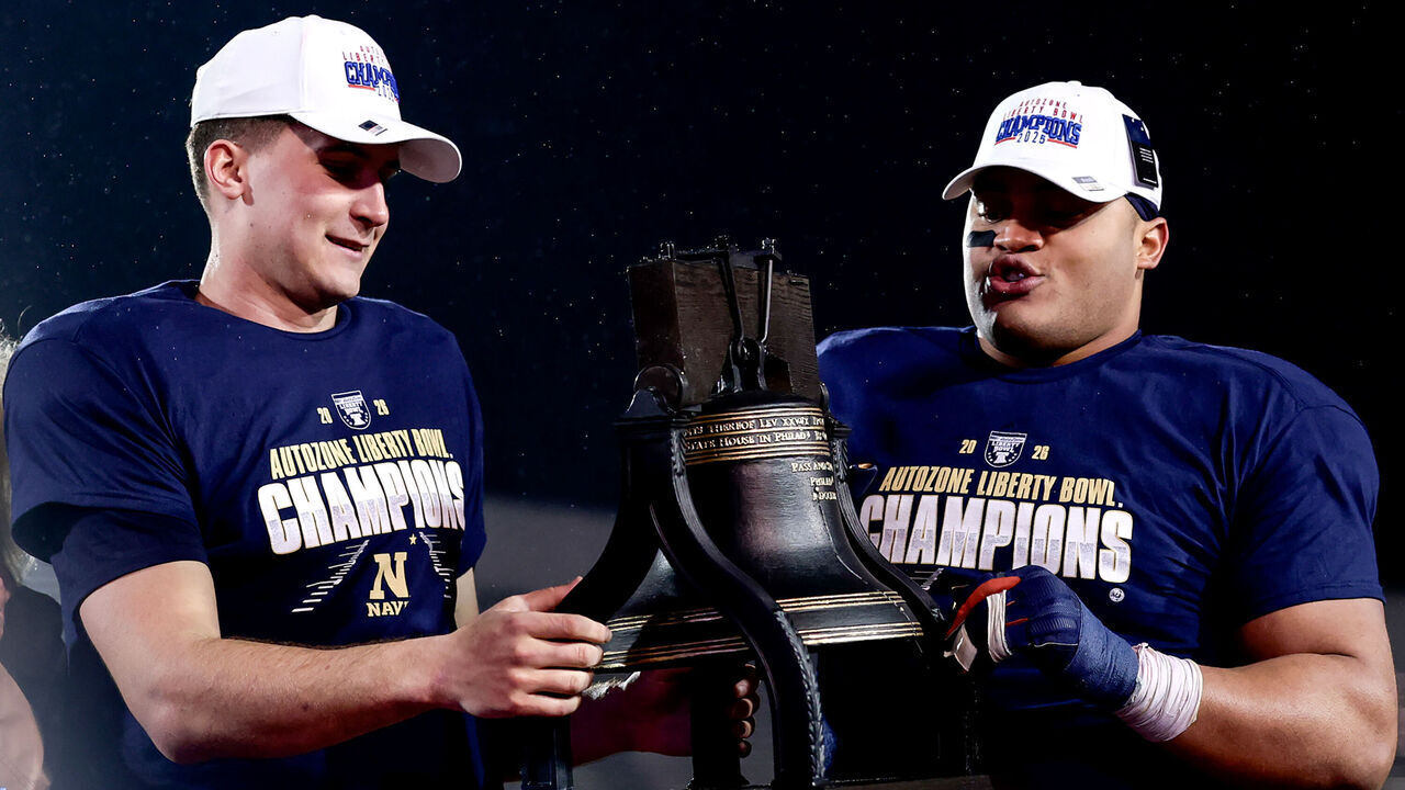 MEMPHIS, TN - JANUARY 02: Navy Midshipmen quarterback Blake Horvath (L) and nose guard Landon Robinson (R) hold the trophy after winning the AutoZone Liberty Bowl game, between the Cincinnati Bearcats and the Navy Midshipmen on January 2, 2026, at Simmons Bank Liberty Stadium in Memphis, Tennessee.