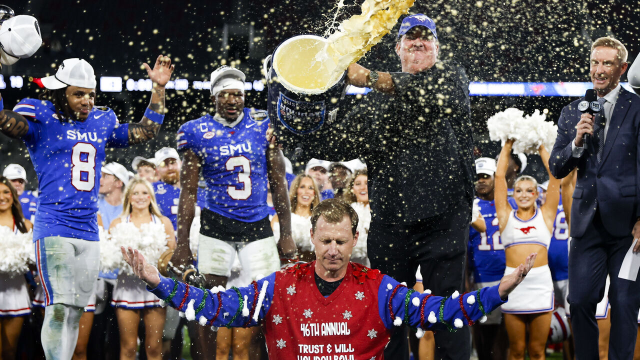 San Diego, California - January 02: Actor Brian Baumgartner tosses eggnog over Rhett Lashlee of SMU after the Mustangs defeated Arizona during the Holiday Bowl at Snapdragon Stadium on Friday, Jan. 2, 2026 in San Diego, California.