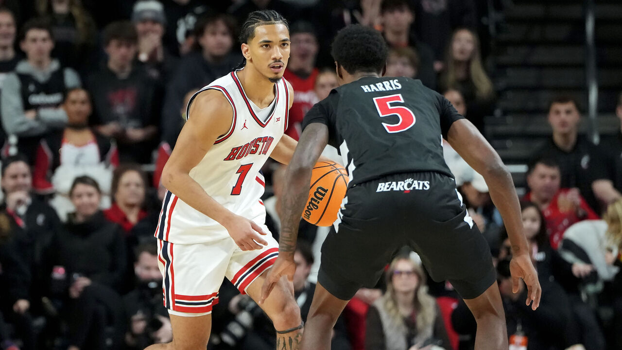 CINCINNATI, OHIO - JANUARY 03: Milos Uzan #7 of the Houston Cougars dribbles the ball while being guarded by Sencire Harris #5 of the Cincinnati Bearcats in the second half at Fifth Third Arena on January 03, 2026 in Cincinnati, Ohio.