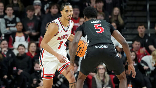 CINCINNATI, OHIO - JANUARY 03: Milos Uzan #7 of the Houston Cougars dribbles the ball while being guarded by Sencire Harris #5 of the Cincinnati Bearcats in the second half at Fifth Third Arena on January 03, 2026 in Cincinnati, Ohio.