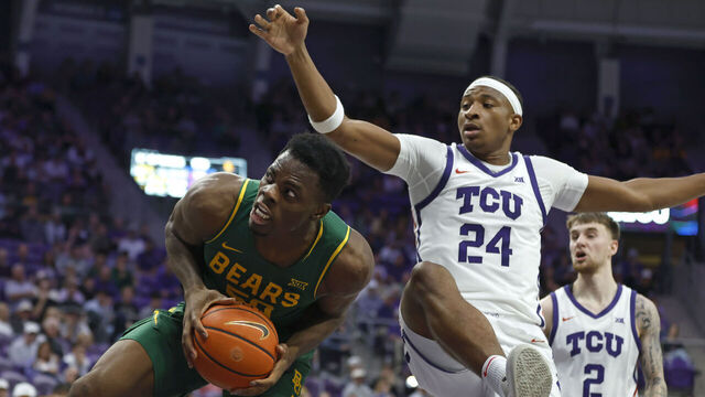 FORT WORTH, TEXAS - JANUARY 3: James Nnaji #50 of the Baylor Bears rebounds against Xavier Edmonds #24 of the TCU Horned Frogs during the first half on January 3, 2026 in Fort Worth, Texas.