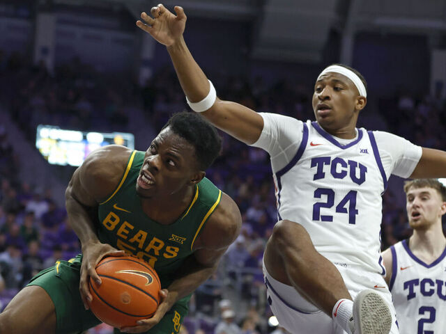 FORT WORTH, TEXAS - JANUARY 3: James Nnaji #50 of the Baylor Bears rebounds against Xavier Edmonds #24 of the TCU Horned Frogs during the first half on January 3, 2026 in Fort Worth, Texas.