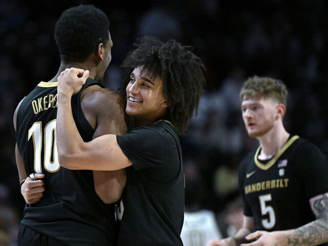 WINSTON SALEM, NORTH CAROLINA - DECEMBER 21: Tyler Tanner #3 of the Vanderbilt Commodores embraces Ak Okereke #10 during the second half of the game against the Wake Forest Demon Deacons at Lawrence Joel Veterans Memorial Coliseum on December 21, 2025 in Winston Salem, North Carolina.