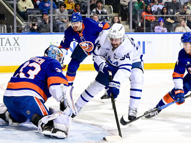 ELMONT, NEW YORK - JANUARY 03: Auston Matthews #34 of the Toronto Maple Leafs scores a goal past David Rittich #33 of the New York Islanders during the second period at UBS Arena on January 03, 2026 in Elmont, New York.