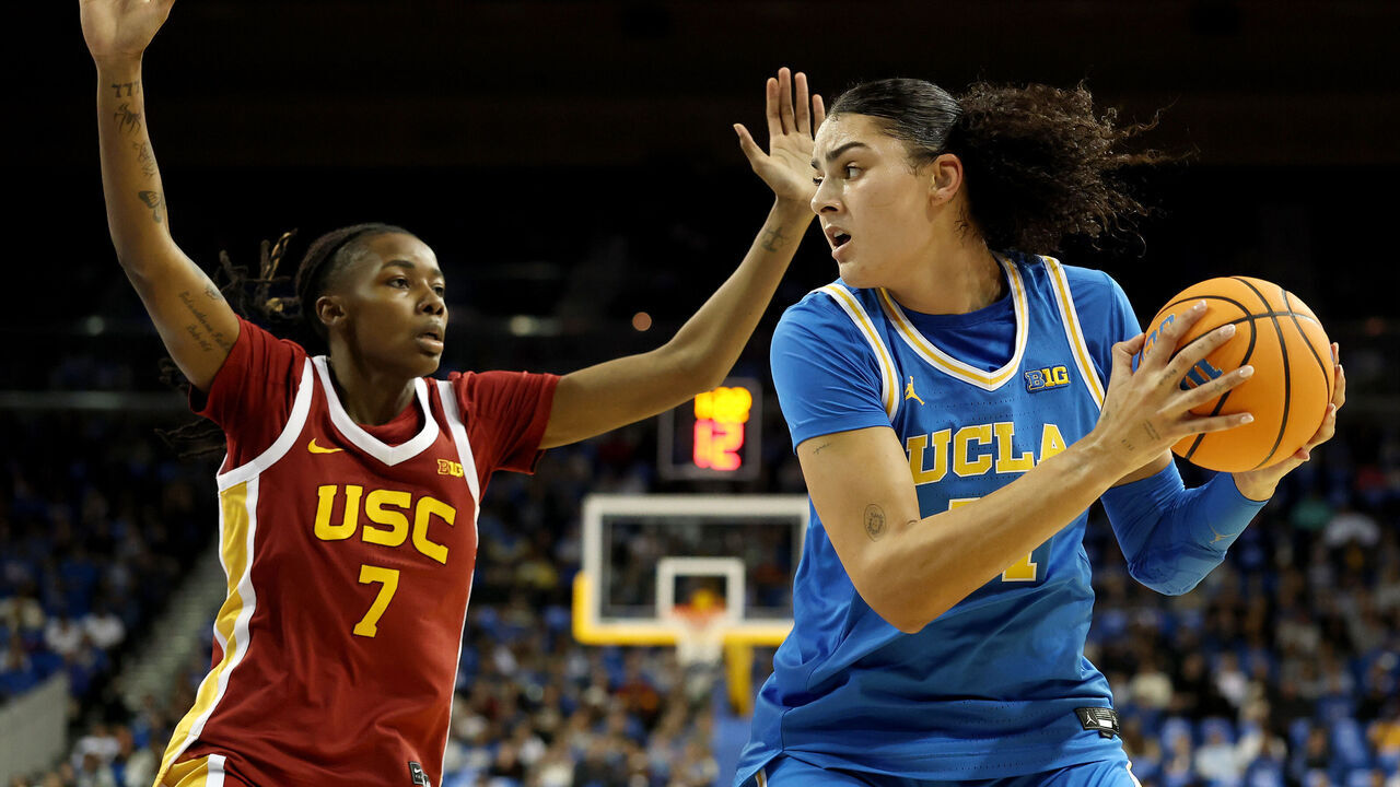 LOS ANGELES, CALIFORNIA - JANUARY 03: Lauren Betts #51 of the UCLA Bruins dribbles the ball against Yakiya Milton #7 of the USC Trojans during the first quarter at UCLA Pauley Pavilion on January 03, 2026 in Los Angeles, California.