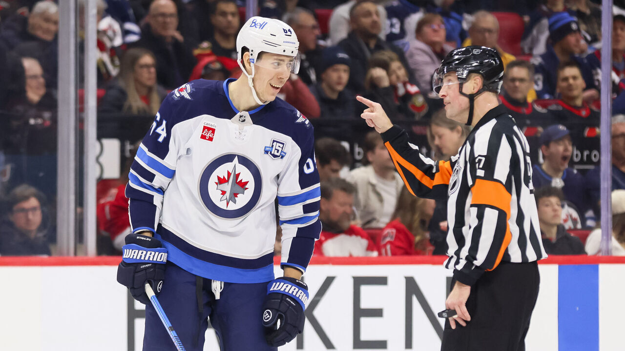 OTTAWA, ON - JANUARY 03: Logan Stanley #64 of the Winnipeg Jets complains about a call to Referee Eric Furlatt #27 during a game against the Ottawa Senators on January 3, 2026, at Canadian Tire Centre in Ottawa, ON, Canada.