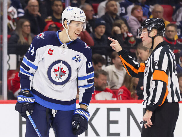 OTTAWA, ON - JANUARY 03: Logan Stanley #64 of the Winnipeg Jets complains about a call to Referee Eric Furlatt #27 during a game against the Ottawa Senators on January 3, 2026, at Canadian Tire Centre in Ottawa, ON, Canada.