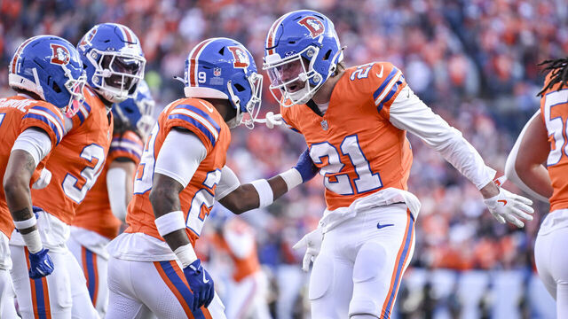 DENVER , CO - JANUARY 4: Ja'quan McMillian (29) of the Denver Broncos celebrates his pick six with Riley Moss (21) during the first quarter against the Los Angeles Chargers at Empower Field at Mile High in Denver, Colorado on Sunday, January 4, 2026.