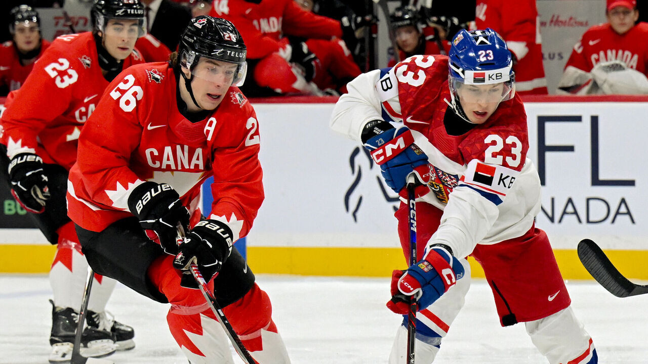 ST PAUL, MINNESOTA - JANUARY 4: Tomas Galvas #23 of Czechia controls the puck as Cole Beaudoin #26 of Canada back checks in the first period of a semifinal game during the IIHF World Junior Hockey Championship at Grand Casino Arena on January 04, 2026 in St Paul, Minnesota.