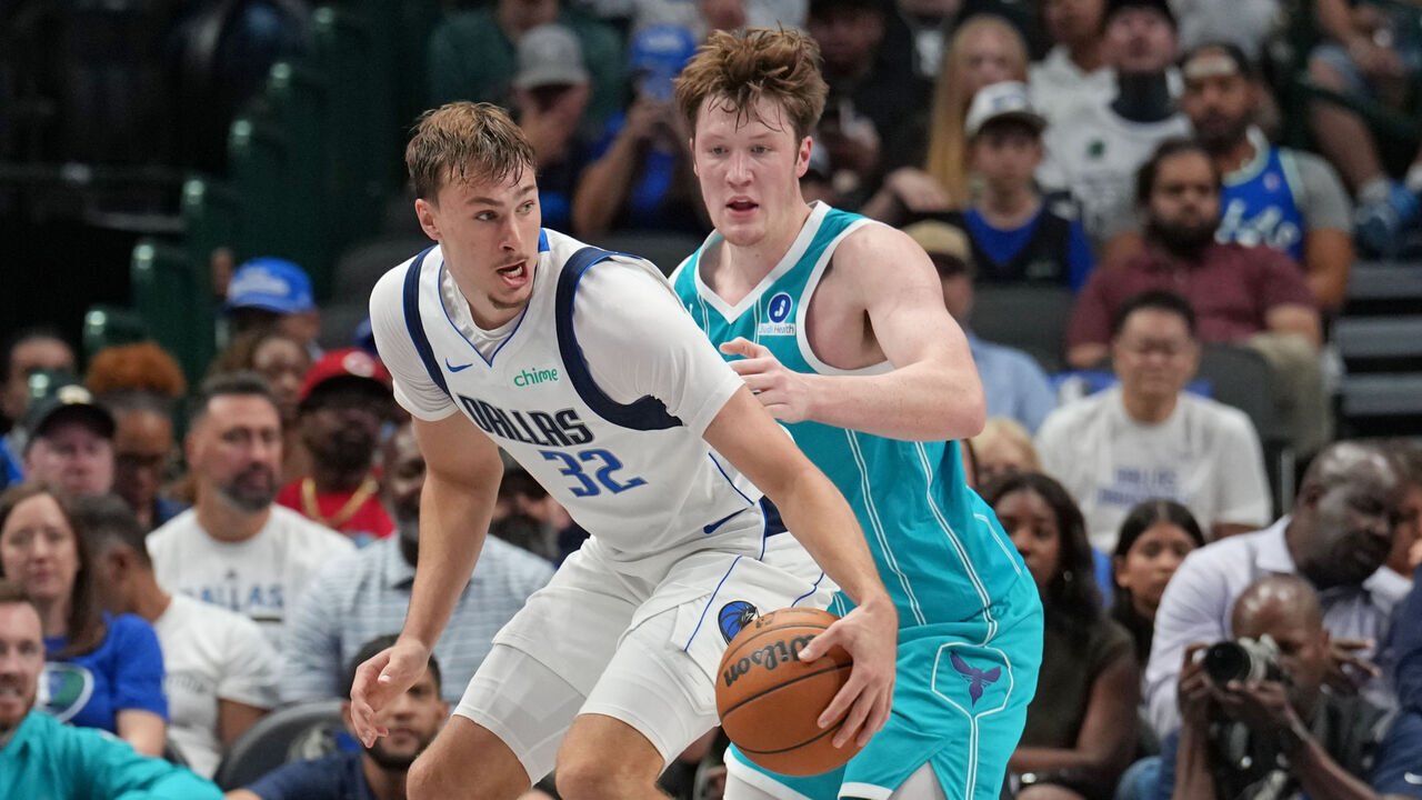 DALLAS, TX - OCTOBER 11: Cooper Flagg #32 of the Dallas Mavericks is guarded by Kon Knueppel #7 of the Charlotte Hornets during a pre-season game on October 11, 2025 at American Airlines Center in Dallas, Texas. Mandatory Copyright Notice: Copyright 2025 NBAE