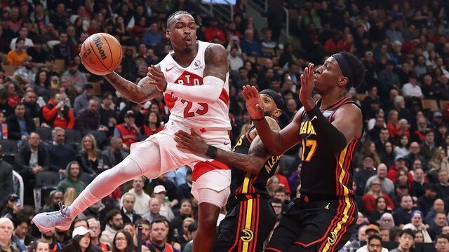 TORONTO, ON- JANUARY 5 - Guard Jamal Shead (23) of the Toronto Raptors dishes off a pass past forward Onyeka Okongwu (17) of the Atlanta Hawks as the Toronto Raptors play the Atlanta Hawks at Scotiabank Arena in Toronto. January 5, 2026. Steve Russell/Toronto Star (Steve Russell/Toronto Star via Getty Images)