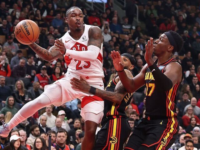 TORONTO, ON- JANUARY 5 - Guard Jamal Shead (23) of the Toronto Raptors dishes off a pass past forward Onyeka Okongwu (17) of the Atlanta Hawks as the Toronto Raptors play the Atlanta Hawks at Scotiabank Arena in Toronto. January 5, 2026. Steve Russell/Toronto Star (Steve Russell/Toronto Star via Getty Images)
