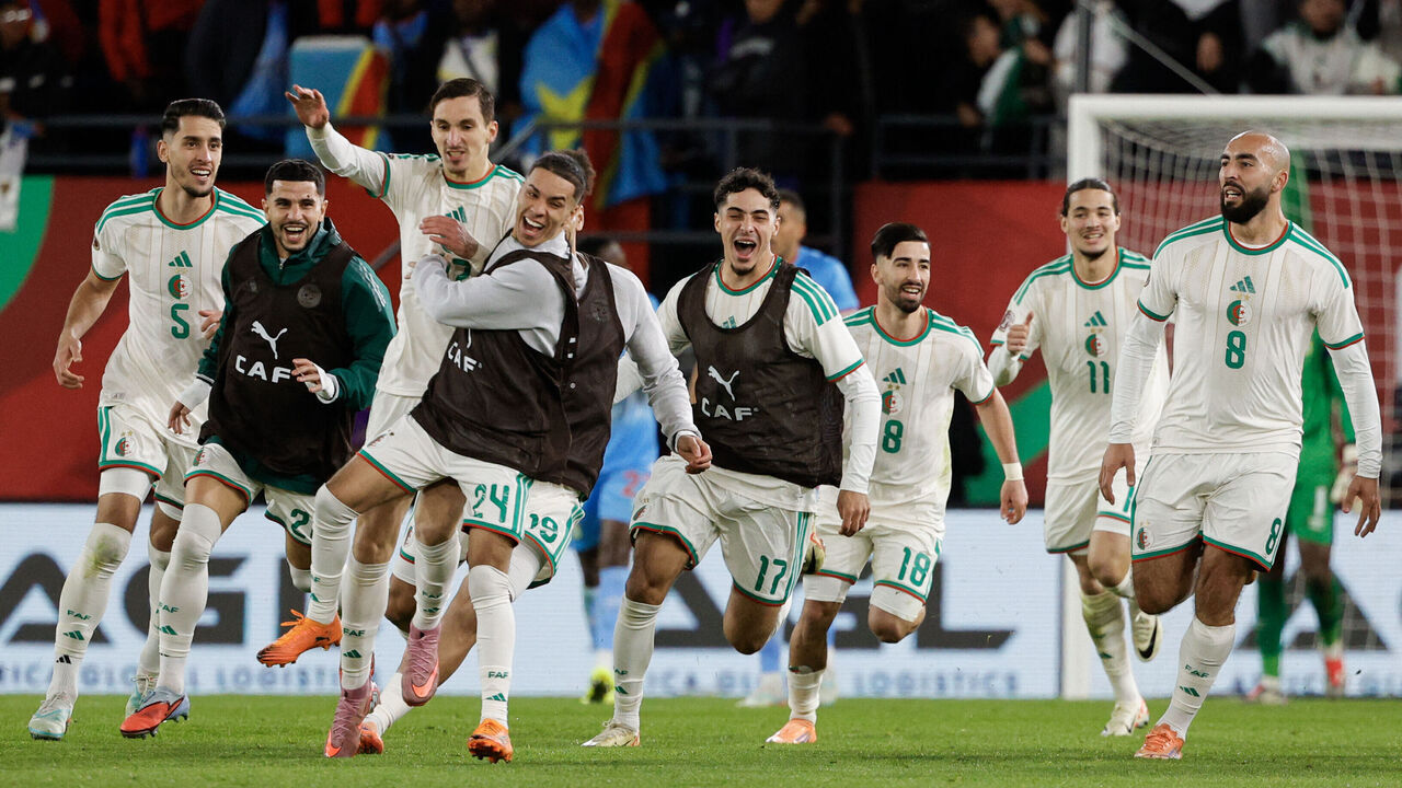 TOPSHOT - Algeria's forward #27 Adil Boulbina (3L) who scored his team's first goal celebrates with teammates after the Africa Cup of Nations (CAN) round of 16 football match between Algeria and Democratic Republic of Congo at the Prince Moulay El Hassan stadium in Rabat on January 6, 2026.
