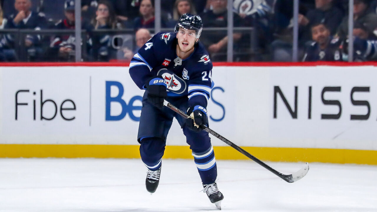 WINNIPEG, CANADA - OCTOBER 9: Haydn Fleury #24 of the Winnipeg Jets plays the puck up the ice during first period action against the Dallas Stars at the Canada Life Centre on October 9, 2025 in Winnipeg, Manitoba, Canada. The Stars defeated the Jets 5-4.
