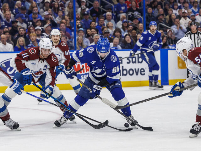 TAMPA, FL - JANUARY 6: Nikita Kucherov #86 of the Tampa Bay Lightning against Brock Nelson #11 and Gavin Brindley #54 of the Colorado Avalanche at Benchmark International Arena on January 6, 2026 in Tampa, Florida.