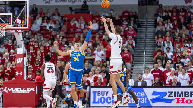Nolan Winter #31 of the Wisconsin Badgers shoots a three-pointer over Tyler Bilodeau #34 of the UCLA Bruins at the Kohl Center in Madison, Wisconsin, on January 6, 2026.