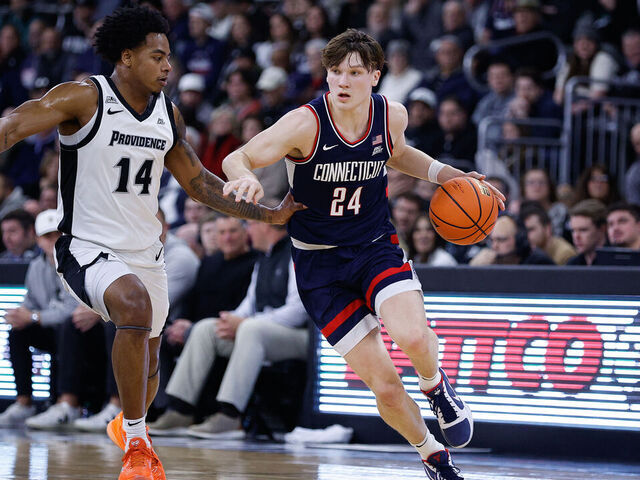 PROVIDENCE, RI - JANUARY 07: Braylon Mullins #24 of the UConn Huskies drives to the basket against Jr. Corey Floyd #14 of the Providence Friars during the college basketball game between UConn Huskies and Providence Friars on January 7, 2026, at Amica Mutual Pavilion in Providence, RI.