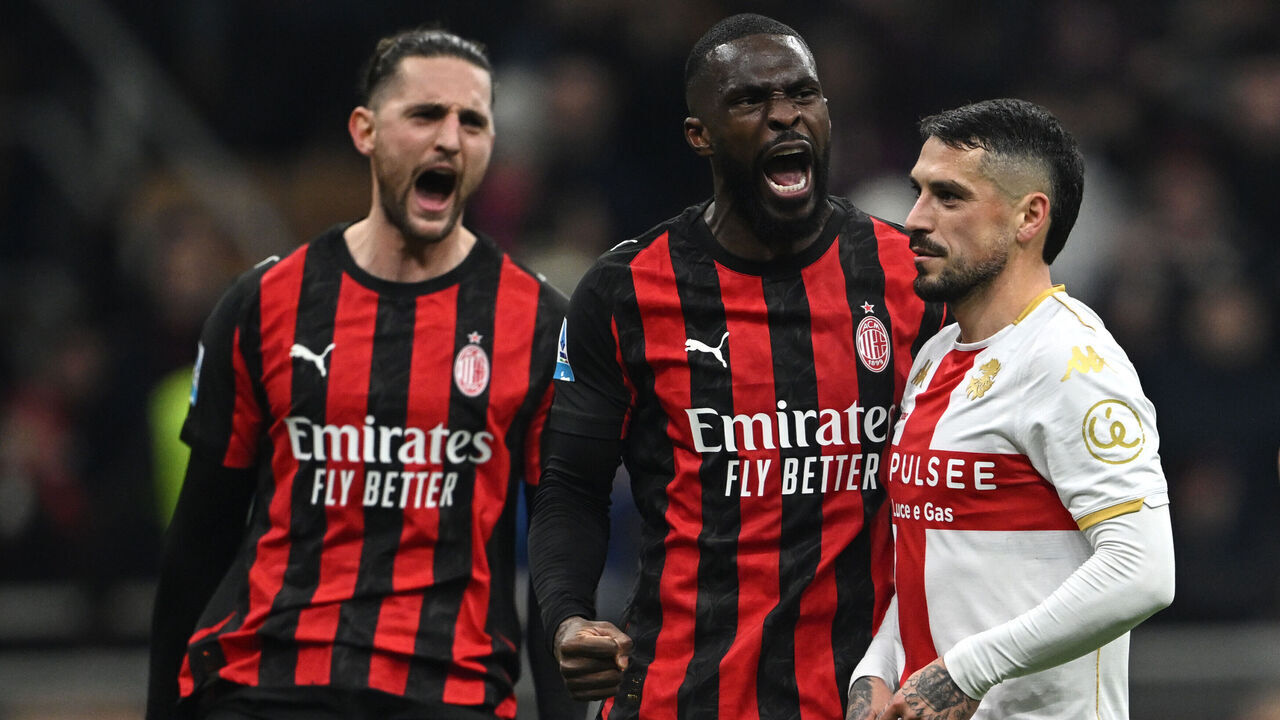 MILAN, ITALY - JANUARY 08: Fikayo Tomori of Milan and Adrien Rabiot of Milan celebrates, Nicolae Stanciu of Genoa disappointment during the Serie A match between AC Milan and Genoa CFC at Giuseppe Meazza Stadium on January 08, 2026 in Milan, Italy.