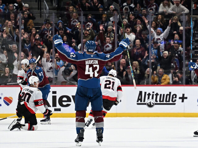DENVER, CO- JANUARY 8: Colorado Avalanche defenseman Josh Manson (42) throws his arms into the air in celebration after scoring a goal during the second period as the Colorado Avalanche take on the Ottawa Senators at Ball Arena in Denver, Colorado on January 8, 2026.