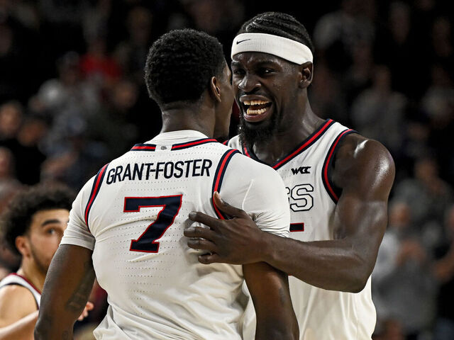 SPOKANE, WASHINGTON - JANUARY 02: Graham Ike #15 and Tyon Grant-Foster #7 of the Gonzaga Bulldogs celebrate a defensive turnover during overtime at McCarthey Athletic Center on January 02, 2026 in Spokane, Washington.