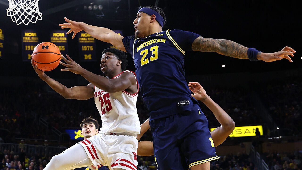 ANN ARBOR, MICHIGAN - JANUARY 10: John Blackwell #25 of the Wisconsin Badgers drives to the basket against Yaxel Lendeborg #23 of the Michigan Wolverines during the second half at Crisler Arena on January 10, 2026 in Ann Arbor, Michigan.