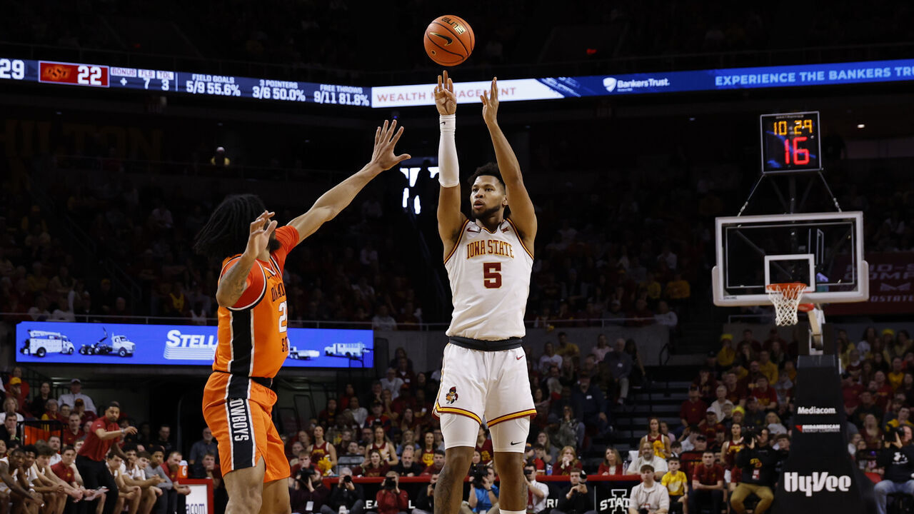 AMES, IA - JANUARY 10: Joshua Jefferson #5 of the Iowa State Cyclones takes a three point shot as Parsa Fallah #22 of the Oklahoma State Cowboys blocks in the first half of play at Hilton Coliseum on January 10, 2026, in Ames, Iowa.