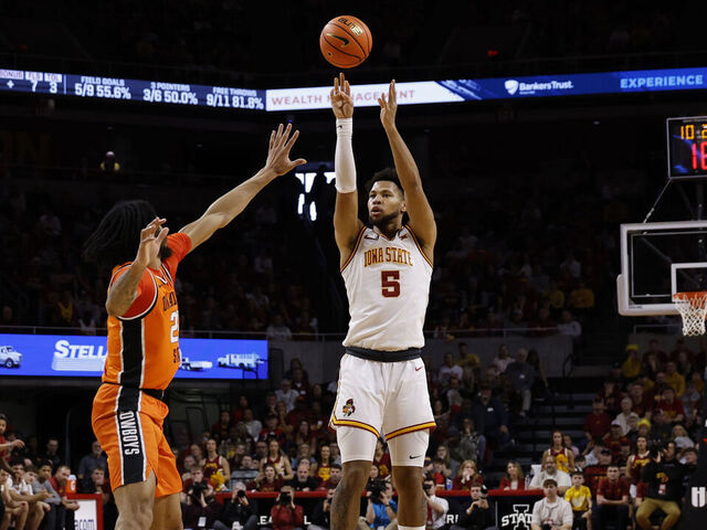 AMES, IA - JANUARY 10: Joshua Jefferson #5 of the Iowa State Cyclones takes a three point shot as Parsa Fallah #22 of the Oklahoma State Cowboys blocks in the first half of play at Hilton Coliseum on January 10, 2026, in Ames, Iowa.