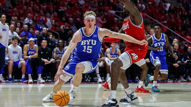 SALT LAKE CITY, UTAH - JANUARY 10: Richie Saunders #15 of the BYU Cougars drives past Seydou Traore #0 of the Utah Utes during the second half of the game at Jon M. Huntsman Center on January 10, 2026 in Salt Lake City, Utah.