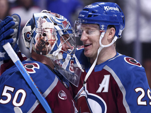 DENVER, COLORADO - JANUARY 10: Trent Miner #50 and Nathan MacKinnon #29 of the Colorado Avalanche celebrate their 4-0 win over the Columbus Blue Jackets at Ball Arena on January 10, 2026 in Denver, Colorado.