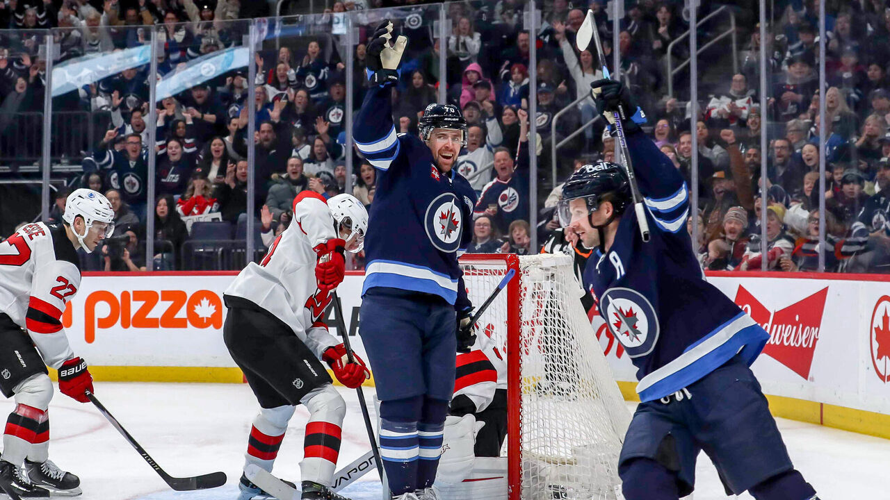 WINNIPEG, CANADA - JANUARY 11: Tanner Pearson #70 and Josh Morrissey #44 of the Winnipeg Jets celebrate a third period goal against the New Jersey Devils at the Canada Life Centre on January 11, 2026 in Winnipeg, Manitoba, Canada.