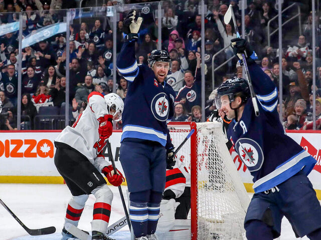 WINNIPEG, CANADA - JANUARY 11: Tanner Pearson #70 and Josh Morrissey #44 of the Winnipeg Jets celebrate a third period goal against the New Jersey Devils at the Canada Life Centre on January 11, 2026 in Winnipeg, Manitoba, Canada.