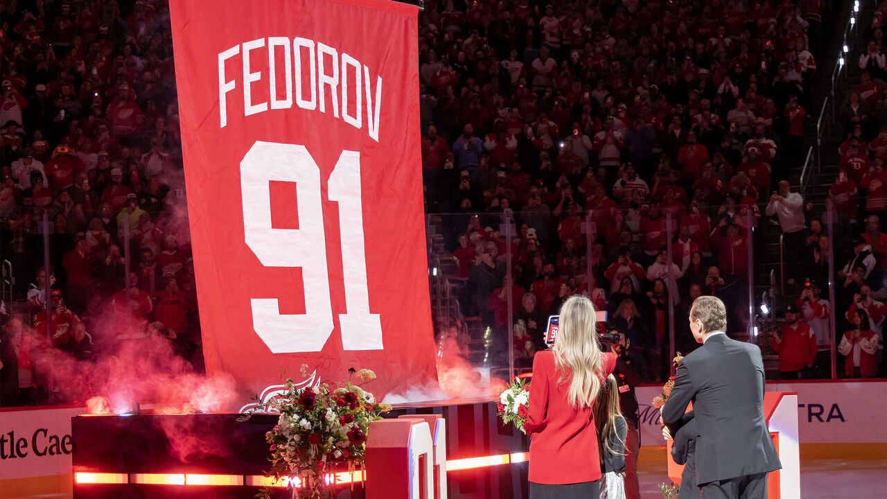 DETROIT, MICHIGAN - JANUARY 12: Former Detroit Red Wing Sergei Fedorov #91, his wife Karina, daughter Alexandra and son Viktor in front of his retirement banner before the game between the Carolina Hurricane and the Detroit Red Wings Caesars Arena on January 12, 2026 in Detroit, Michigan.