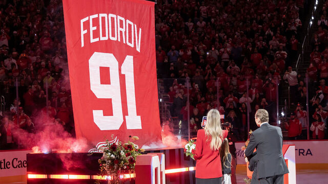 DETROIT, MICHIGAN - JANUARY 12: Former Detroit Red Wing Sergei Fedorov #91, his wife Karina, daughter Alexandra and son Viktor in front of his retirement banner before the game between the Carolina Hurricane and the Detroit Red Wings Caesars Arena on January 12, 2026 in Detroit, Michigan.