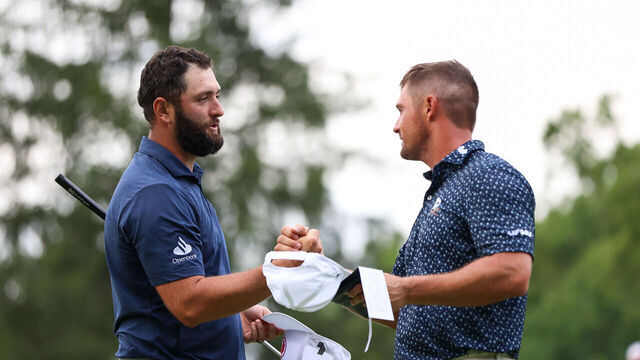 WHITE SULPHUR SPRINGS, WEST VIRGINIA - AUGUST 16: Jon Rahm of Spain hand shakes Bryson DeChambeau of the United States after finishing the 18th hole during day one of LIV Golf: Greenbrier at The Old White Course on August 16, 2024 in White Sulphur Springs, West Virginia.