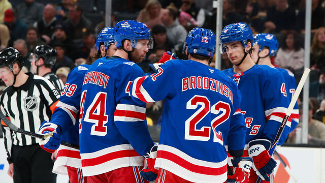 BOSTON, MA - JANUARY 10: Sam Carrick #39 of the New York Rangers, Vladislav Gavrikov #44 of the New York Rangers, Jonny Brodzinski #22 of the New York Rangers, and Braden Schneider #4 of the New York Rangers talk on the power play during the game between the Boston Bruins and the New York Rangers on January 10, 2026, at TD Garden in Boston, MA.