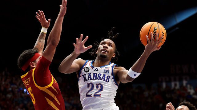 LAWRENCE, KANSAS - JANUARY 13: Darryn Peterson #22 of the Kansas Jayhawks drives to the basket as Tamin Lipsey #3 and Joshua Jefferson #5 of the Iowa State Cyclones defend during the first half of the game at Allen Fieldhouse on January 13, 2026 in Lawrence, Kansas.