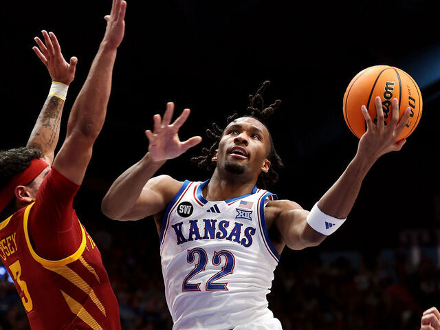 LAWRENCE, KANSAS - JANUARY 13: Darryn Peterson #22 of the Kansas Jayhawks drives to the basket as Tamin Lipsey #3 and Joshua Jefferson #5 of the Iowa State Cyclones defend during the first half of the game at Allen Fieldhouse on January 13, 2026 in Lawrence, Kansas.