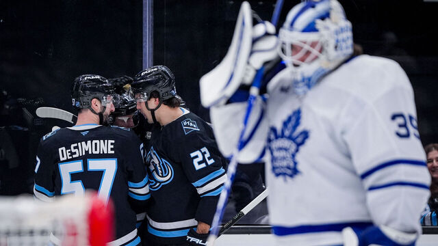 SALT LAKE CITY, UTAH - JANUARY 13: Nick DeSimone #57, Dylan Guenther #11, and Jack McBain #22 of the Utah Mammoth celebrate a goal during the second period at Delta Center on January 13, 2025 in Salt Lake City, Utah.
