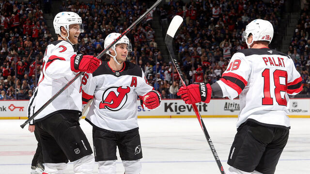 DENVER, COLORADO - OCTOBER 28: Dougie Hamilton #7, Jack Hughes #86 and Ondrej Palat #18 of the New Jersey Devils celebrate after a goal against the Colorado Avalanche at Ball Arena on October 28, 2025 in Denver, Colorado.