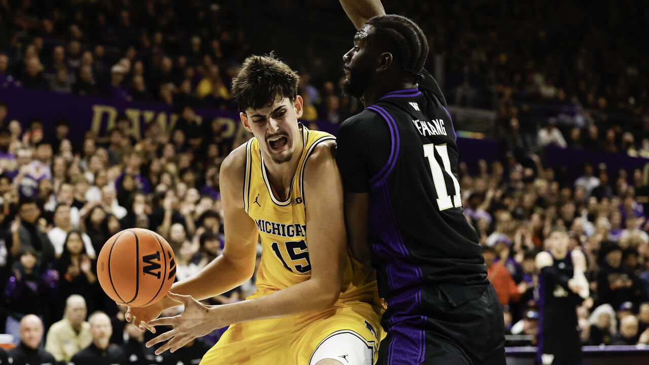 SEATTLE, WASHINGTON - JANUARY 14: Aday Mara #15 of the Michigan Wolverines controls the ball against Franck Kepnang #11 of the Washington Huskies during the first half of the game at the Alaska Airlines Arena on January 14, 2026 in Seattle, Washington.