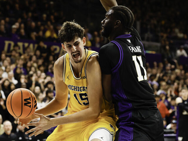 SEATTLE, WASHINGTON - JANUARY 14: Aday Mara #15 of the Michigan Wolverines controls the ball against Franck Kepnang #11 of the Washington Huskies during the first half of the game at the Alaska Airlines Arena on January 14, 2026 in Seattle, Washington.