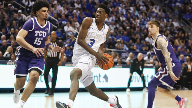 PROVO, UT - JANUARY 14: AJ Dybantsa #3 of the Brigham Young Cougars drives the lane against David Punch #15 and Brock Harding #2 of the Texas Christian University Horned Frogs during the second half at the Marriott Center on January 14, 2026 in Provo, Utah.