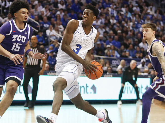 PROVO, UT - JANUARY 14: AJ Dybantsa #3 of the Brigham Young Cougars drives the lane against David Punch #15 and Brock Harding #2 of the Texas Christian University Horned Frogs during the second half at the Marriott Center on January 14, 2026 in Provo, Utah.