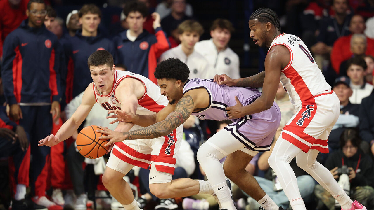 TUCSON, ARIZONA - JANUARY 07: Ivan Kharchenkov #8 of the Arizona Wildcats and PJ Haggerty #4 of the Kansas State Wildcats reach for a loose ball during the first half of the NCAAB game at McKale Center on January 07, 2026 in Tucson, Arizona.