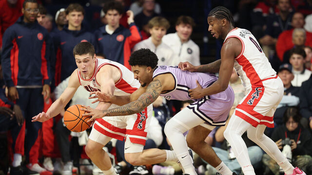 TUCSON, ARIZONA - JANUARY 07: Ivan Kharchenkov #8 of the Arizona Wildcats and PJ Haggerty #4 of the Kansas State Wildcats reach for a loose ball during the first half of the NCAAB game at McKale Center on January 07, 2026 in Tucson, Arizona.
