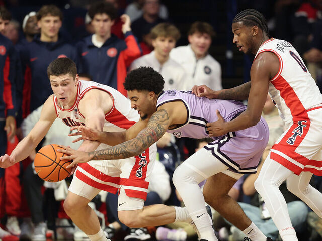 TUCSON, ARIZONA - JANUARY 07: Ivan Kharchenkov #8 of the Arizona Wildcats and PJ Haggerty #4 of the Kansas State Wildcats reach for a loose ball during the first half of the NCAAB game at McKale Center on January 07, 2026 in Tucson, Arizona.